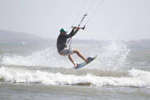 a man riding a wave on a surfboard in the ocean at Casa de Playa Nativo in Cartagena de Indias