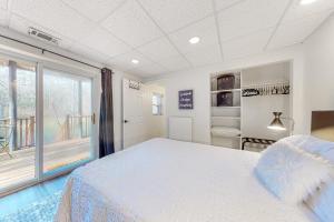 a bedroom with a bed and a large window at Creekside Cottage in Blairsville