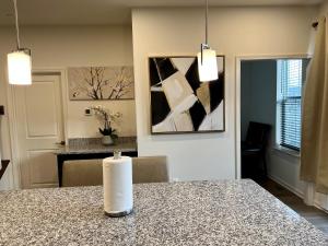a room with a table with a vase on a counter at Apple House- New Townhouse - 2 Car Garage by CCBC & Franklin Sq in Rosedale
