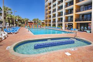 a swimming pool in front of a hotel at Ocean Blvd Studio, Unit 419 in Myrtle Beach