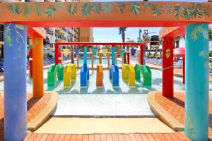 a playground in a park with colorful equipment at Ocean Blvd Studio, Unit 419 in Myrtle Beach