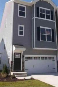 a large gray house with a white garage at Apple House- New Townhouse - 2 Car Garage by CCBC & Franklin Sq in Rosedale