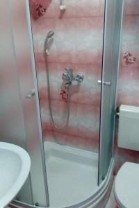 a shower in a bathroom with a toilet and a sink at Apartments by the sea Dugi Rat, Omis - 21074 in Dugi Rat