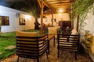 a group of chairs and a table in a patio at Ahomé Guest house & Lounge in Lomé