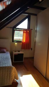 a bedroom with a bed and a window at Chalé JS in São Bento do Sul