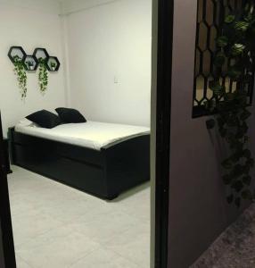 a small bed in a room with at HABITACIÓN INDEPENDIENTE CERCA AL CENTRO in Santa Marta