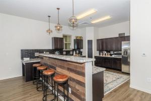 a large kitchen with a large counter with stools at Granite Apartment - Prescott Cabin Rentals in Prescott