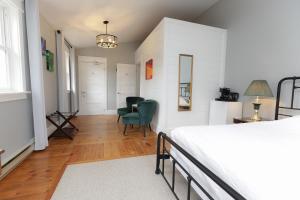 a bedroom with a bed and a desk and a chair at Jackson's Falls Country Inn in Milford