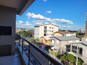 a balcony with a view of a city at Apartamento espaçoso e impecável in Bento Gonçalves