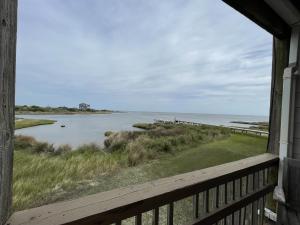 a view of the ocean from a house window at SW 1 STARFISH condo in Hatteras