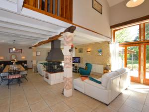 a living room with a fireplace in a house at Charming holiday home with pool in Lavercantière
