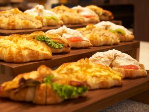 a bunch of different types of food on wooden trays at CROSS Life Hakata Tenjin in Fukuoka