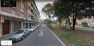 a row of cars parked next to a building at XXV Aprile in Ferrara