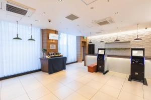 a lobby with a cash register and a counter at Sotetsu Fresa Inn Tokyo-Toyocho in Tokyo