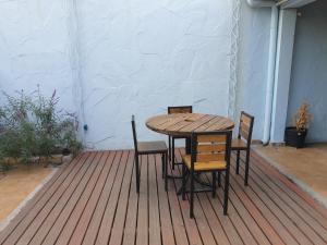 a wooden table and chairs on a deck at FourDoor in Guaymallen