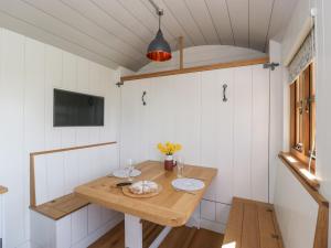 a small dining room with a table and a tv at Little Hut in Weston-super-Mare