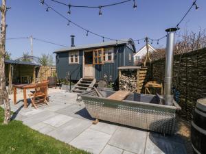 a backyard with a fire pit and a house at Little Hut in Weston-super-Mare