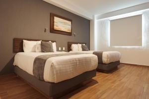Krevet ili kreveti u jedinici u okviru objekta Hoteles Unico Express