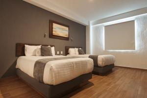 Postel nebo postele na pokoji v ubytování Hoteles Unico Express
