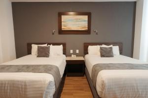 Postel nebo postele na pokoji v ubytování Hoteles Unico Express