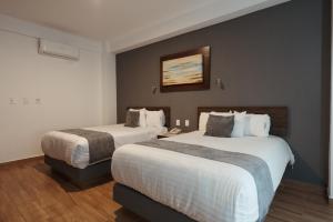 Postel nebo postele na pokoji v ubytování Hoteles Unico Express