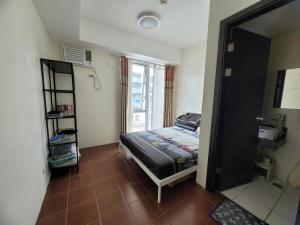 a bedroom with a bed and a window at Kasara relaxing abode in Manila