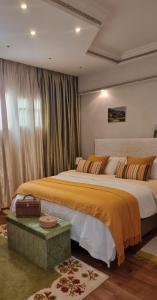 a bedroom with two beds and a large window at Appart 5min de l'aéroport & tramway in Salé