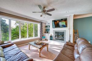 a living room with a couch and a fireplace at Lake Keowee Condo with Balcony and Resort Amenities! in Salem