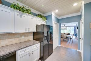a kitchen with a refrigerator and a dining room at Lake Keowee Condo with Balcony and Resort Amenities! in Salem