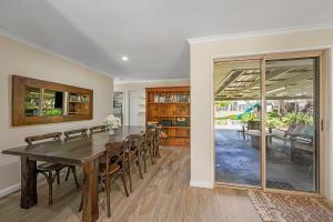 a dining room with a table and chairs at Pet Friendly Family Home with Pool Close to Theme Parks in Gold Coast