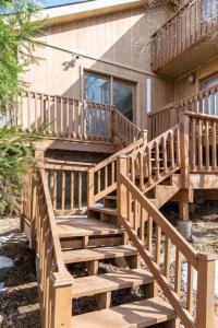 a wooden staircase leading up to a house at Spacious Cabin with Private Covered Hot Tub in Albrightsville