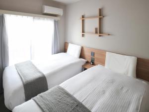 东京浅草筑波快速船舶酒店(Vessel Inn Asakusa Tsukuba Express)房間的床