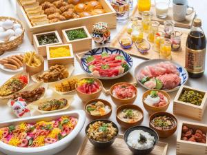 a table topped with lots of different types of food at Vessel Inn Asakusa Tsukuba Express in Tokyo