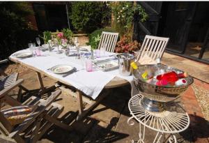 a table with two chairs and a bowl of flowers on it at Church Farm Bed and Breakfast 