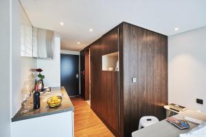 a kitchen with a wooden cabinet in a room at Jeju Pureun Hotel in Seogwipo +41 photos