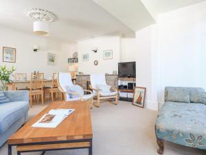 a living room with a couch and a table at Edinburgh House in Salcombe