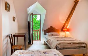 a room with two beds and a desk and a window at Holiday Home Luche Pringe O-925 in Le Lude +24 photos
