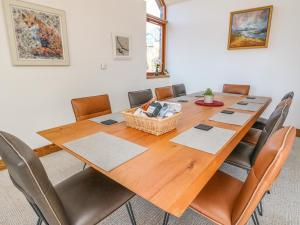 a conference room with a wooden table and chairs at Balvaig in Pitlochry