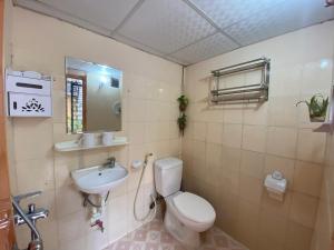 a bathroom with a toilet and a sink at T30 Hanoi Homestay, near Lotte Tay Ho, 25minutes to the airport in Hanoi