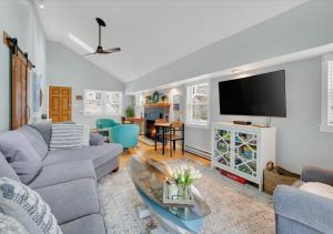 a living room with a couch and a tv at Sunset Cove in East Hampton