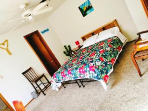 a bedroom with a bed with a colorful bedspread at Golden Sunflower's Apartment B1 in Lawton