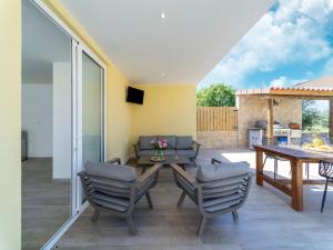 a patio with a table and chairs and a dining room at Rural Holiday Home with Pool in Lagares