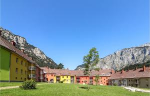 a group of buildings with mountains in the background at Amazing Apartment In Eisenerz With 2 Bedrooms And Wifi in Eisenerz