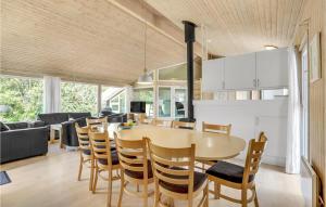 a kitchen and dining room with a table and chairs at Stunning Home In Vggerlse With Sauna, Wifi And Indoor Swimming Pool in Bøtø By