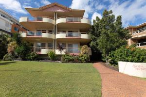 a large apartment building with a lawn in front of it at Haven Waters 3 in Forster