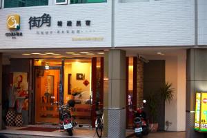 a building with two motorcycles parked outside of it at 街角民宿--近火車站 in Hualien City