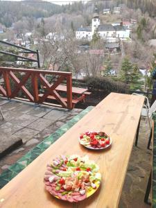 a wooden table with two plates of food on it at Chalupa Grant in Špania Dolina