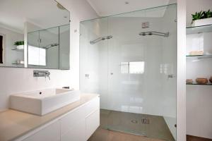 a bathroom with a sink and a glass shower at 2 20 Kingfisher Dr Peregian Beach in Peregian Beach