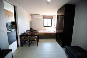 a small room with a dining table and a bedroom at VIP Great Hill in Thalang