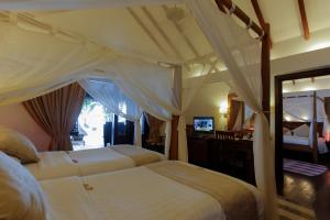 Postel nebo postele na pokoji v ubytování Medhufushi Island Resort